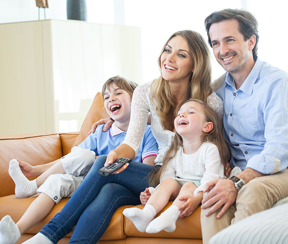 Family enjoying television together at home